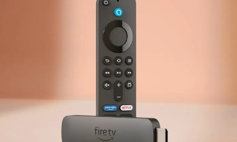 Amazon Fire TV Stick 4K and remote on a light orange surface.