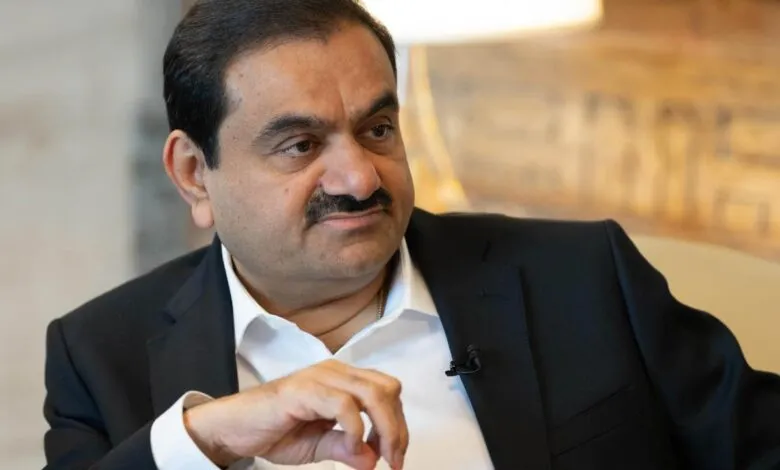 Gautam Adani in a suit, looking off to the side.