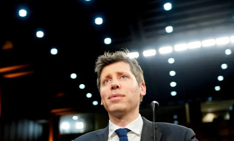 Man in suit and tie looks upward in a brightly lit room.