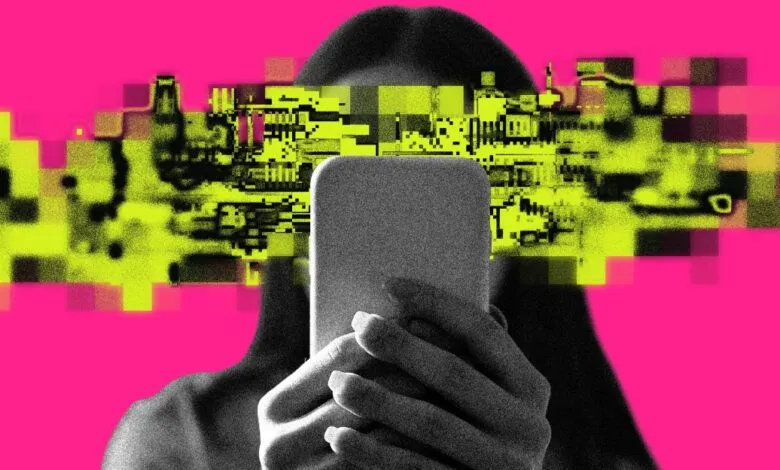 Person holding phone with pixelated face on pink background.