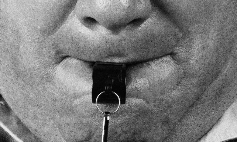 Close-up of a person with a whistle in their mouth.