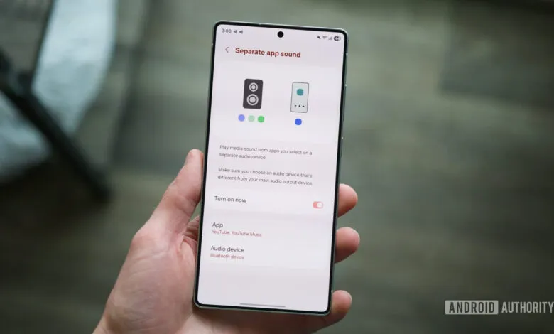 Smartphone displaying 'Separate app sound' settings in hand.