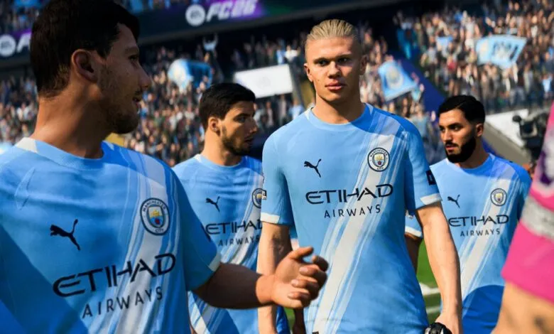 Erling Haaland and teammates in Manchester City FC uniform on the field.