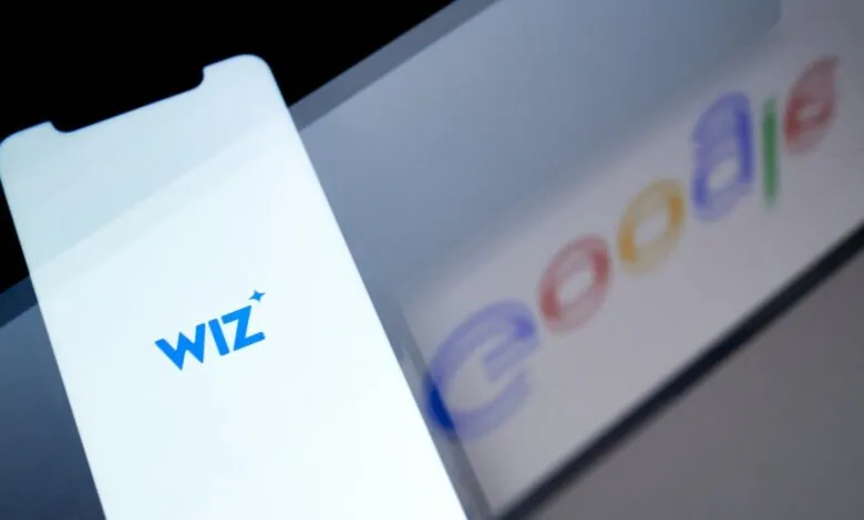 Smartphone displaying Wiz logo with Google logo in background.