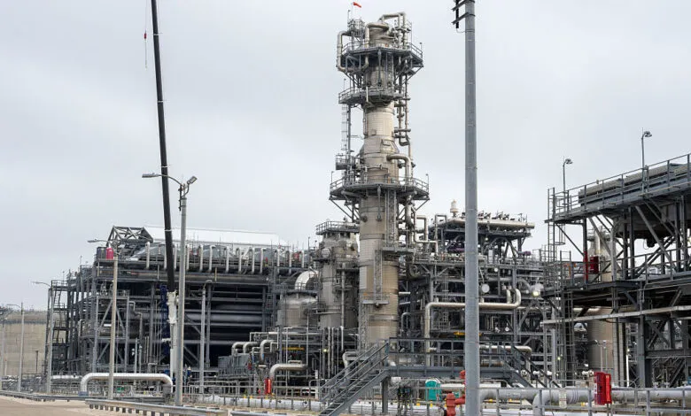 Exterior view of the Freeport LNG facility featuring complex industrial structures and piping.