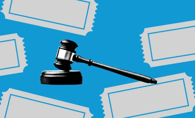 Gavel on block with ticket stubs against a blue background.