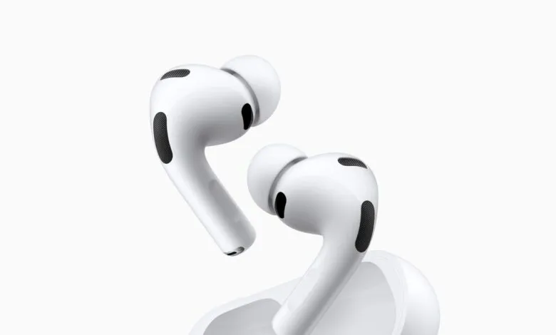 Close-up of white Apple AirPods Pro and charging case on white background.