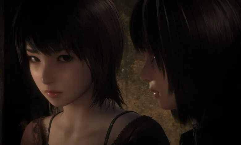 Close-up of two young women with dark hair in a dimly lit setting.