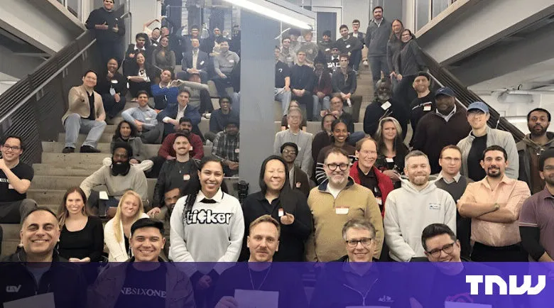 Large group of diverse people posing on stairs for a group photo.