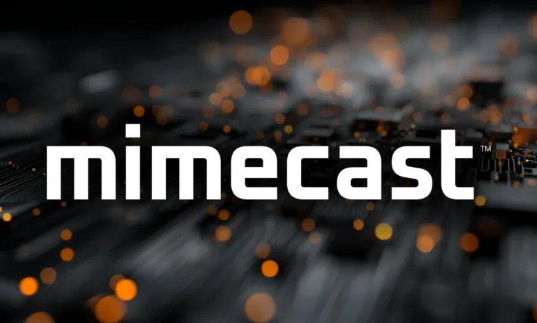 Mimecast logo in white against a blurred circuit board background with orange bokeh.