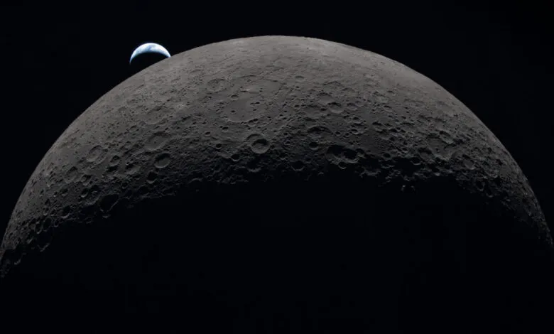 Crescent moon with Earth visible on the horizon, craters visible.