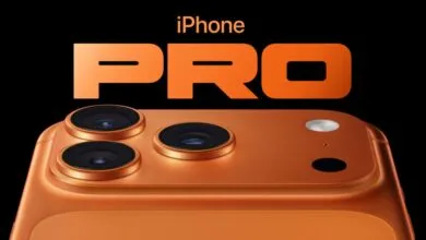Close-up of an orange iPhone Pro with three camera lenses.