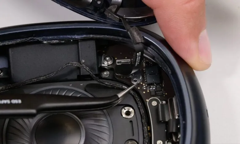 Close-up of AirPods Max internal components during disassembly.