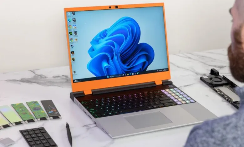 Framework Laptop 16 with customizable modules on a marble surface.