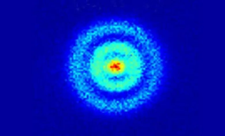Concentric circles of light, red at center, fading to blue at edges.