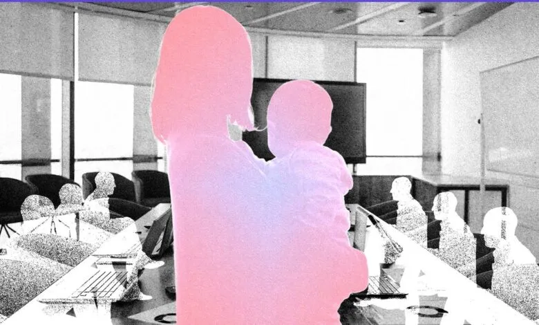 Silhouette of mother holding baby in office meeting room.