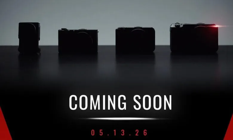 Four silhouetted cameras on a reflective surface with 'COMING SOON' and a date.