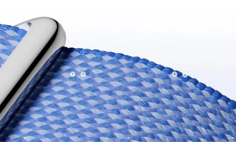 Close-up of a woven blue and white watch band with a silver connector.