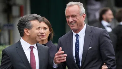 Robert F. Kennedy Jr. and Martin Makary walk together, smiling.