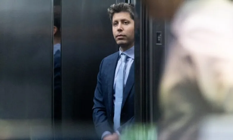 Man in suit stands in elevator, looking forward intently.