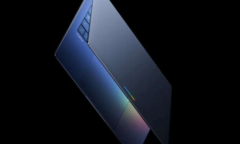 Sleek blue Googlebook laptop on a black background, angled view.