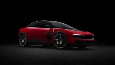 Sleek red Ferrari Purosangue SUV with black accents on a dark background.