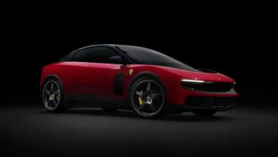 Red Ferrari Purosangue SUV with black accents on a dark background.