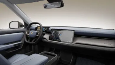 Interior view of a Rivian vehicle showcasing the dashboard and front seats.