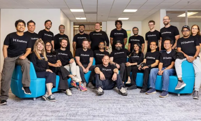 Group of about 20 Exaforce employees posing for a team photo in an office setting.