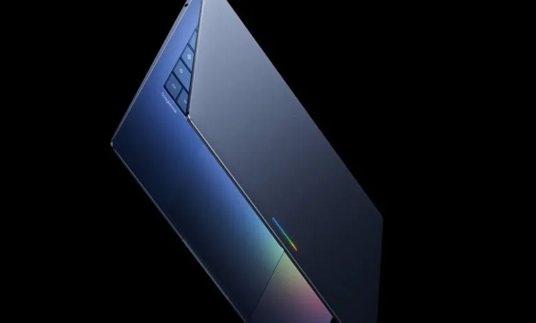Sleek blue Googlebook laptop against a stark black background.