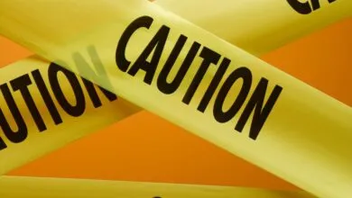 Close-up of yellow caution tape with bold black lettering.