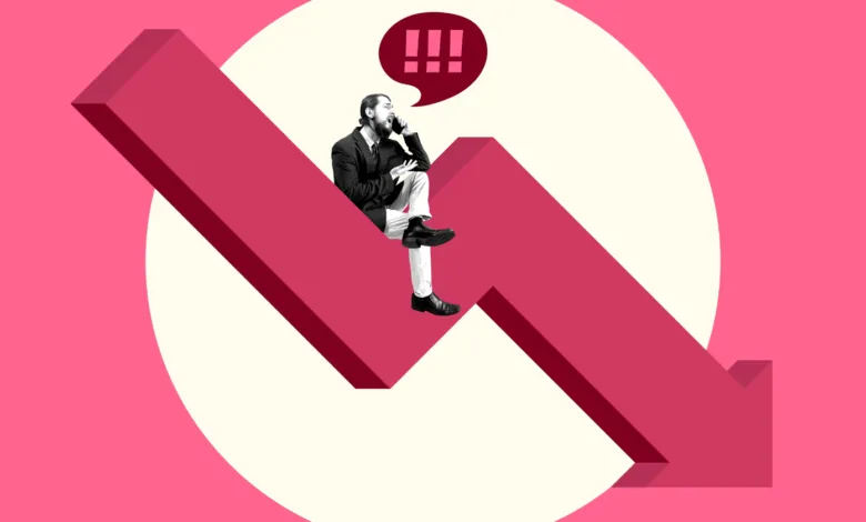 Man on phone sits on downward arrow, symbolizing business decline.