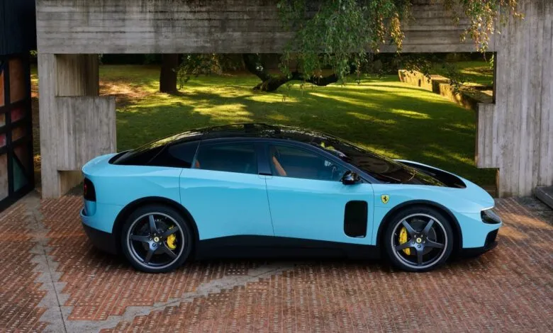 Light blue Ferrari with black roof parked on brick driveway near modern building.