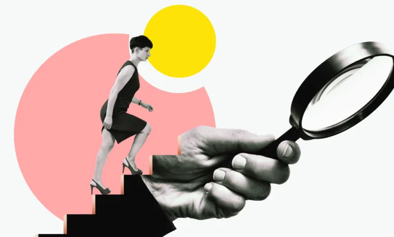 Woman climbs stairs under magnifying glass, symbolizing career growth.