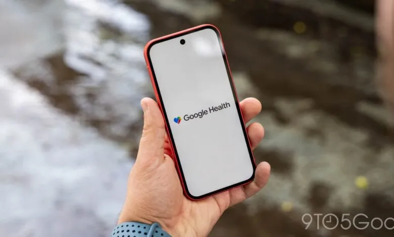 Person holds phone displaying the Google Health logo against blurred background.