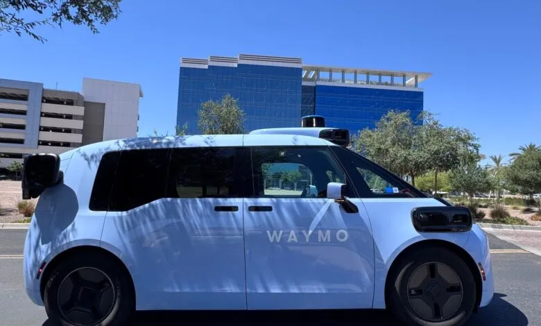 Waymo Zeekr robotaxi parked on a sunny street, showcasing its autonomous driving technology.
