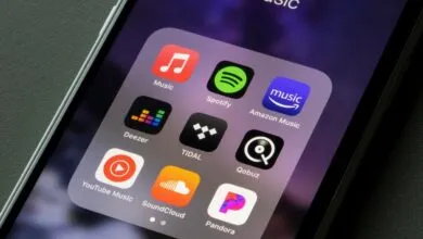 A smartphone screen displaying a folder with popular music streaming apps.