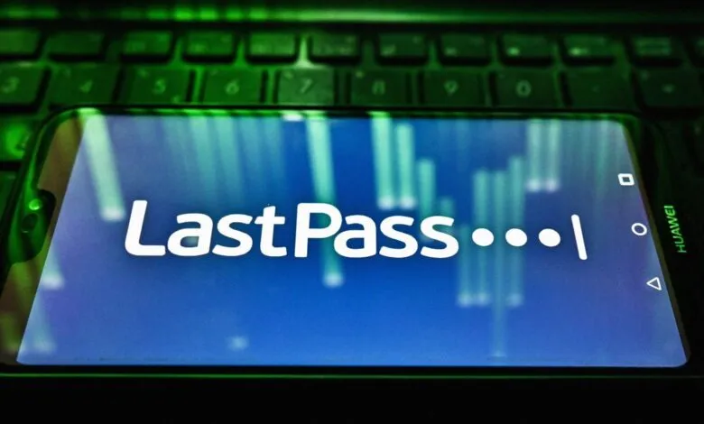 Smartphone displaying the LastPass password manager logo resting on a glowing green keyboard.