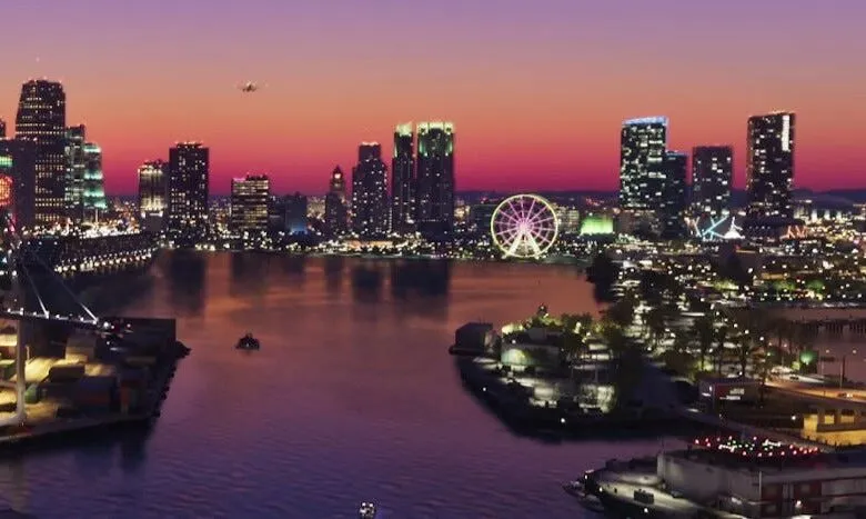 Glowing Ferris wheel stands out against a vibrant pink sunset skyline alongside a waterfront city.