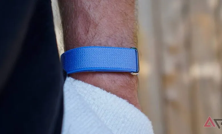Close-up of blue fabric watch band on a hairy wrist.