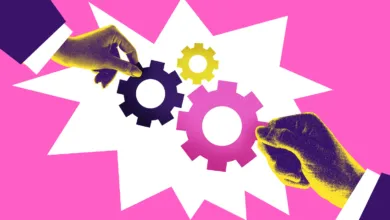 Two stylized hands in suits fitting colorful gears together against a vibrant pink background.