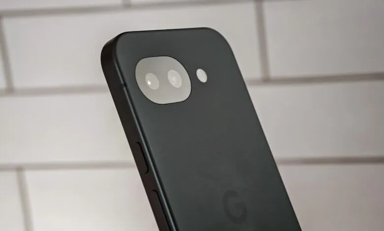 Close-up of a dark smartphone back featuring a horizontal dual-camera module against a tiled wall