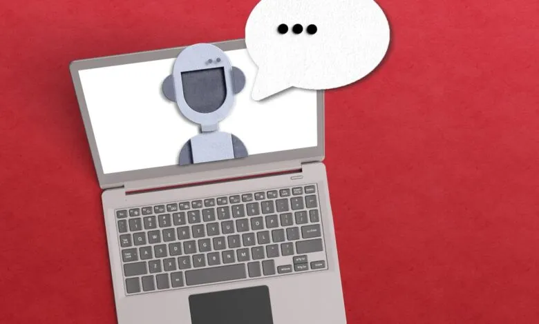 Laptop on red background with papercut robot character and speech bubble on screen