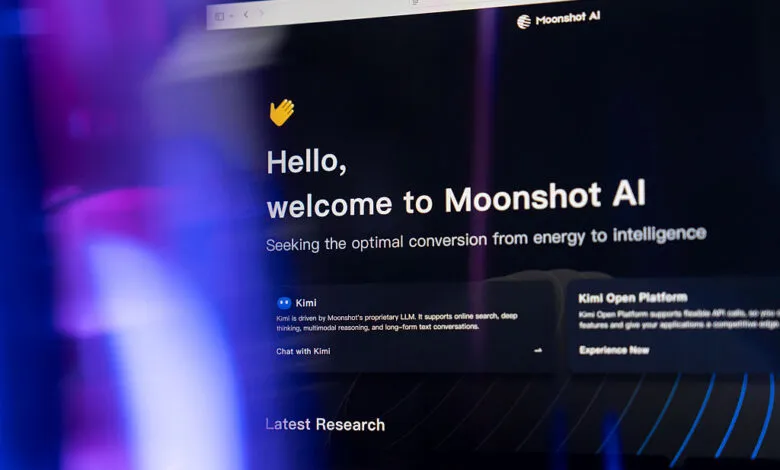 Computer monitor displaying the Moonshot AI website and Kimi chatbot interface with a dark theme.