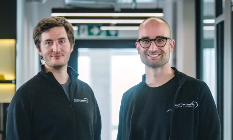 Two male founders of Quantum Diamonds posing together in a modern office environment.