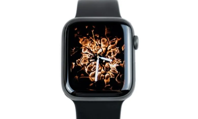 Close-up of an Apple Watch with a dynamic golden fire background on the screen.