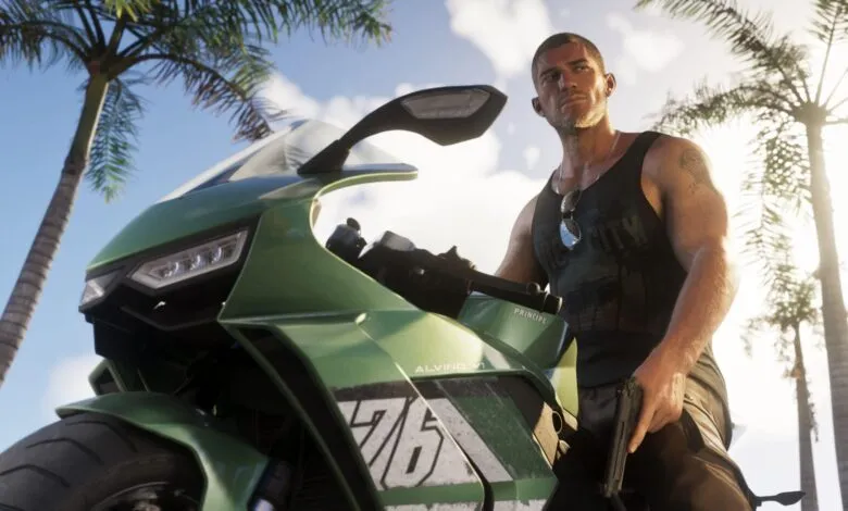 A man in a black tank top sits on a green motorcycle beneath palm trees.