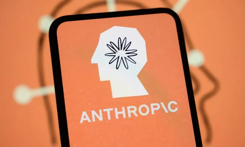Smartphone displaying the Anthropic logo with a stylized head and floral brain on an orange background.