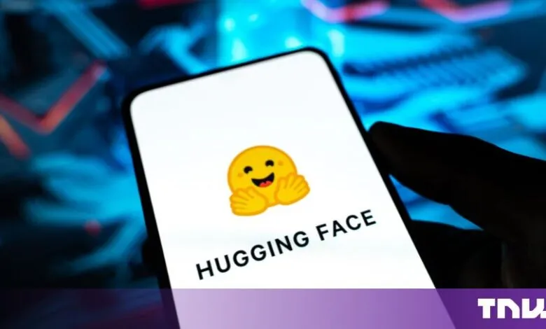 Smartphone displaying the Hugging Face AI platform logo on a white screen.