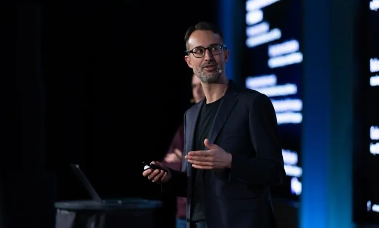 Gael Delalleau, CEO of Kog, speaking on stage at a tech event.